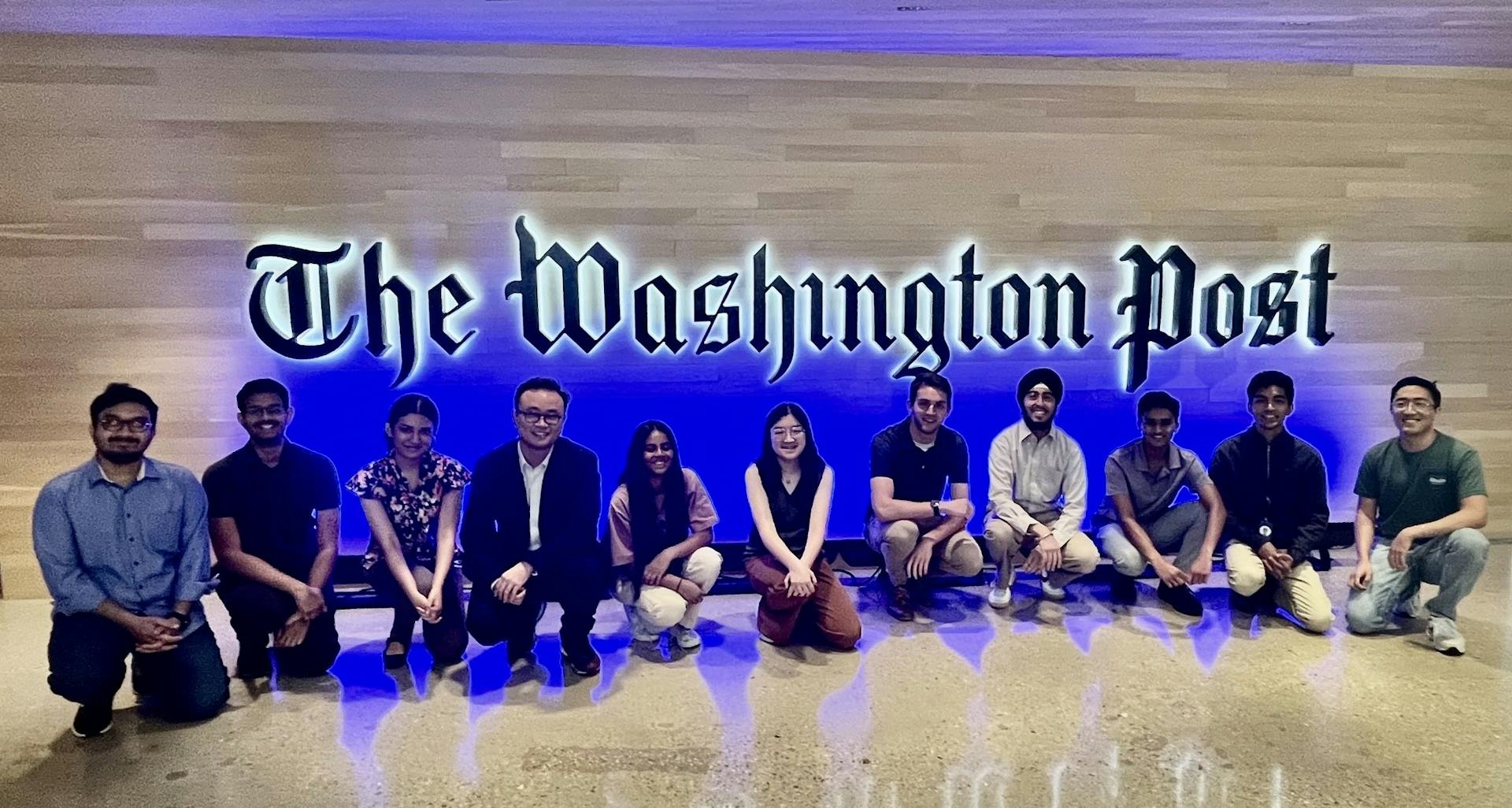 Interns taking a picture by The Washington Post stand in the DC office